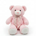 Pink teddy bear with a bow tie on a shelf in a store