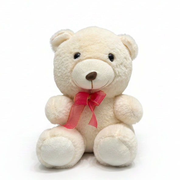 Small white teddy bear with a pink bow attached to a curtain.