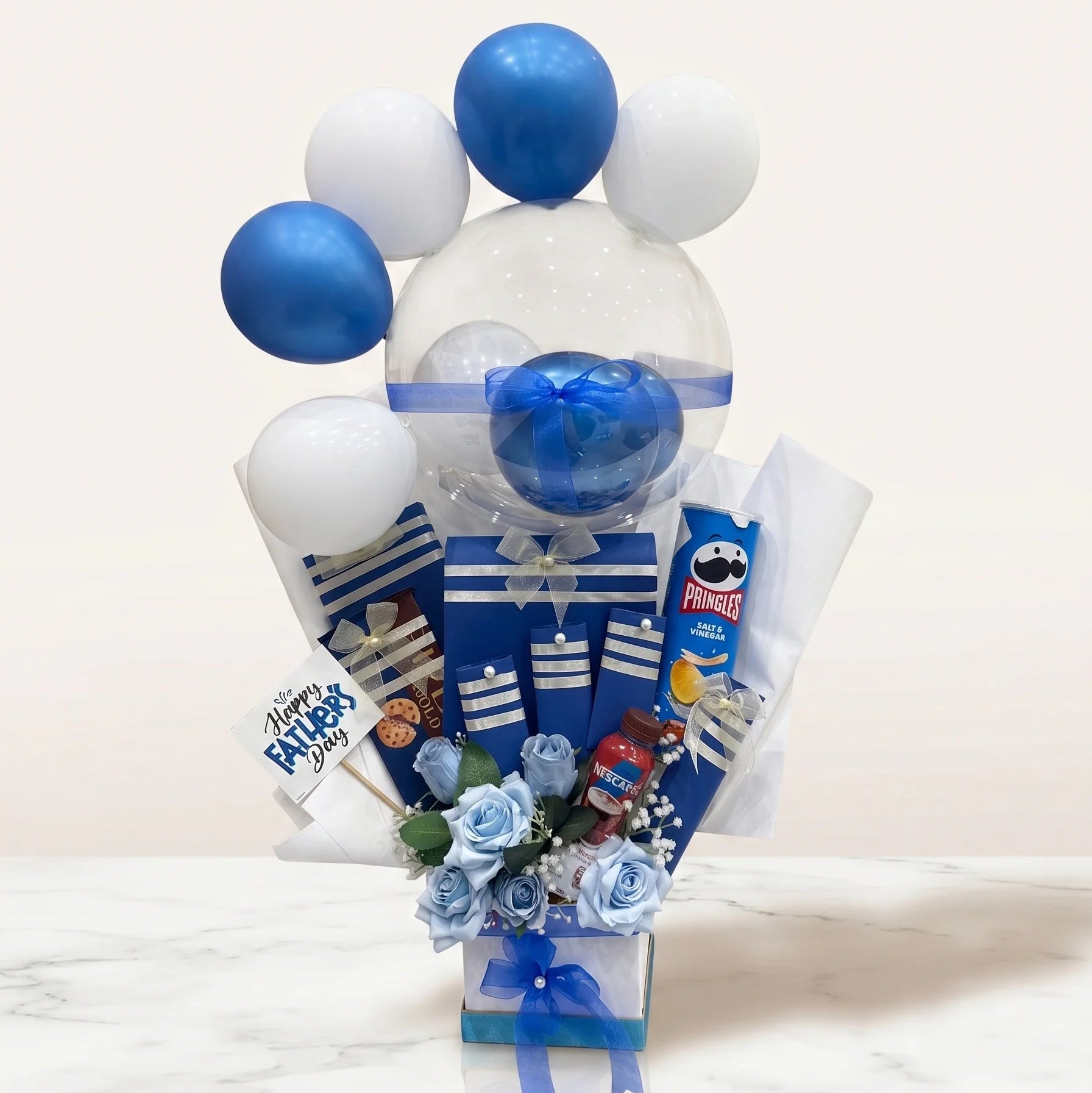Bouquet with balloons and snacks on a white background