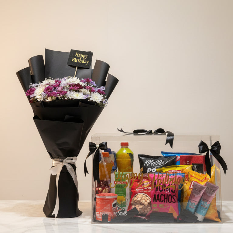 Bouquet of flowers and a gift basket with snacks on a table in a store setting.