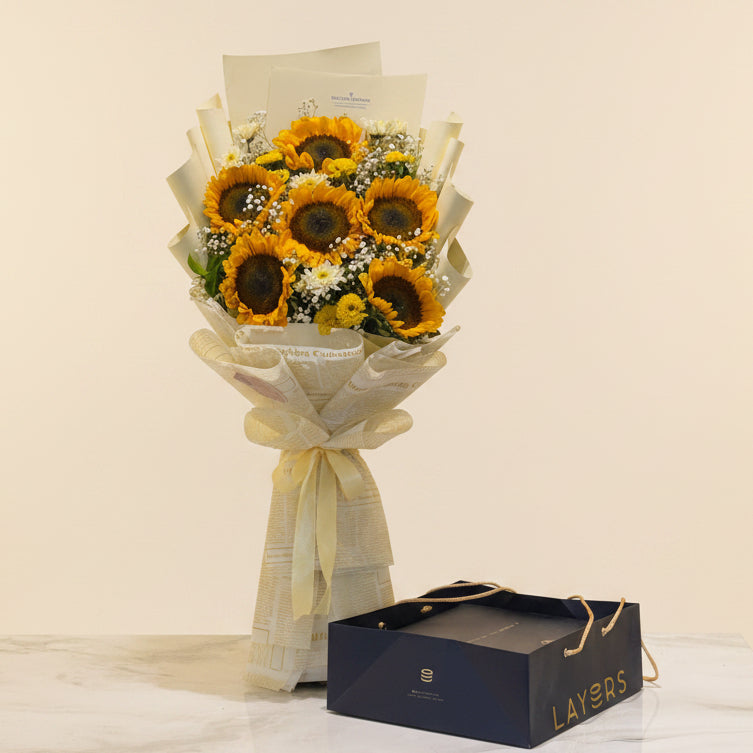 Bouquet of sunflowers with a box labeled 'LAYERS' in a store setting with shelves of products.