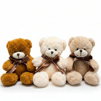 Decorative wall hanging made of teddy bear heads with brown bows in front of a color swatch chart.
