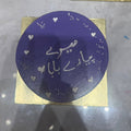 Purple circular design with text on a gold square, placed on a reflective surface.