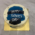 Father's Day cake with police hats and 'Happy Father's Day' text on a metallic surface.
