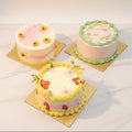 Three decorated cakes on a marble surface